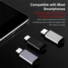 A smartphone is shown next to three small USB-C adapters on a black reflective surface. Náhľad obrázku produktu