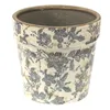 A ceramic flower pot with a floral pattern. Voir les images du produit
