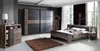 A bedroom scene featuring a bed, wardrobe, and dresser. Produktbild-Vorschau