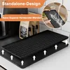 A black silicone mat for a coffee machine, shown on a kitchen counter with bags of coffee beans in the background. An inset image shows water being poured onto a similar mat. Produktbild-Vorschau