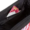 Close-up view of the inside of a bag, showing a small zippered pocket with a product insert. Náhľad obrázku produktu