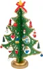 A small, green, wooden Christmas tree decorated with various ornaments and a red bow on top. Anteprima dell’immagine prodotto