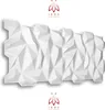 A white, geometric 3D wall panel with a shadow underneath, set against a white background. A logo and text are present at the top and bottom. Produktbild-Vorschau