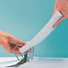 Two hands are holding a stack of white paper, inserting it into a white binder with silver rings. Produktbild-Vorschau