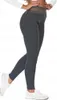 A woman wearing dark gray leggings with a gold waistband that says "STAY COSY" and white sneakers, shown from the side. Produktbild-Vorschau