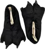 A pair of black, plush slippers shaped like monster or animal paws with claws, shown against a white background. Náhled obrázku produktu
