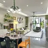A living room with a sofa, dining table, and plants. Voir les images du produit