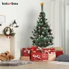 A decorated Christmas tree with presents underneath, next to a fireplace with a wreath. Produktbild-Vorschau