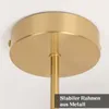 A close-up view of a gold-colored ceiling lamp fixture attached to a white ceiling. Produktbild-Vorschau
