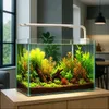 A well-lit aquarium with lush green and orange plants, illuminated by an LED lamp, placed on a wooden cabinet in a modern room. Podgląd zdjęcia produktu