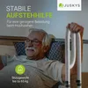 An elderly man is lying in bed, holding onto a bed rail. Náhled obrázku produktu