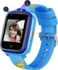 A blue smartwatch for children with two cameras on top, displaying a video call on its screen. The watch band has cartoon dinosaur graphics. Produktbild-Vorschau