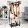A clothing rack with clothes and shoes, next to a shelf and a chair. Anteprima dell’immagine prodotto