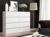 A white dresser is shown in a room with black patterned wallpaper and a floor lamp. Produktbild-Vorschau