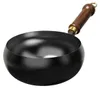 A black wok with a wooden handle on a white background. Produktbild-Vorschau