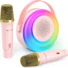 A pink karaoke machine with two pink microphones and a colorful LED light ring. Náhľad obrázku produktu