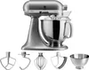 A silver KitchenAid Artisan stand mixer with multiple attachments displayed below it, all on a white background. Podgląd zdjęcia produktu
