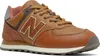 A close-up, studio shot of a New Balance 574 sneaker. Voir les images du produit