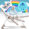 A baby swing with a raccoon illustration and a rainbow in the background. Produktbild-Vorschau