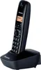 A black Panasonic cordless phone with a handset resting in its charging base, set against a white background. Podgląd zdjęcia produktu