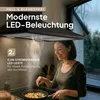 A woman is cooking in a kitchen with a modern range hood above her. Produktbild-Vorschau