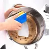 A person is cleaning a dirty pot with a sponge. Podgląd zdjęcia produktu