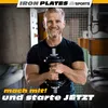 A man is holding a dumbbell in a gym-like setting. Produktbild-Vorschau