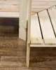 A close-up view of the corner of a wooden shelving unit, showing the construction of the shelves and legs. Produktbild-Vorschau