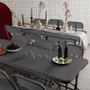 A dark gray plastic folding table and chairs set up for an event, with decorative items on the table. Anteprima dell’immagine prodotto