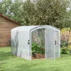 A greenhouse in a backyard setting with a wooden shed and fence. Voir les images du produit