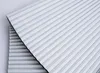 A close-up view of two folded white pleated blinds, stacked on top of each other. Produktbild-Vorschau