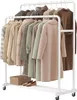 A white rolling garment rack filled with various coats and jackets. Náhled obrázku produktu
