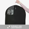 A hand holding a black garment bag with a clear window. Produktbild-Vorschau