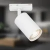 A close-up shot of a white track light fixture against a blurred indoor background. Produktbild-Vorschau
