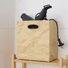 Braune Aufbewahrungsbox mit Föhn im Badezimmerregal Produktbild-Vorschau