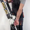 A person in work clothes is holding a multi-purpose ladder. Náhľad obrázku produktu
