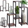 Multiple plant stands of varying sizes and configurations are displayed against a white background, showcasing different arrangements and decorative items. Anteprima dell’immagine prodotto