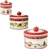 Three Christmas-themed ceramic tins with apple-shaped lids, arranged in a collage. Náhľad obrázku produktu