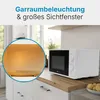 A white microwave oven is shown on a kitchen counter, with a close-up inset of the illuminated interior. Produktbild-Vorschau