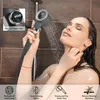 A woman is taking a shower and using a handheld showerhead. Náhled obrázku produktu