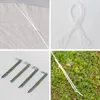 A collage of images showing parts of a party tent, including stakes, ropes, and the tent fabric, as well as a stake in the ground. Voir les images du produit