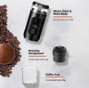 A flat lay image showing components of a portable espresso machine, coffee beans, and ground coffee. Podgląd zdjęcia produktu