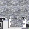 A kitchen counter with a stove and sink, with a brick-patterned wall behind it. An inset shows a close-up of the brick panels. Produktbild-Vorschau