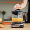A person is using an electric citrus juicer to make orange juice. Produktbild-Vorschau