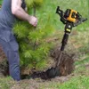 A person is using a portable earth auger to dig a hole next to a small tree. Podgląd zdjęcia produktu
