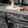 A close-up of an outdoor dining set, including a table and chairs, with fruit and a vase on the table. Náhled obrázku produktu