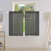 A window with dark gray sheer curtains hanging on a white rod. Produktbild-Vorschau