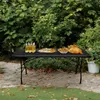 A folding table with food and drinks set up outdoors. Náhľad obrázku produktu