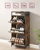 A vintage-style shoe cabinet with three flip-down drawers filled with various shoes. Produktbild-Vorschau