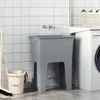 A laundry tub with a faucet and a washing machine in the background. Náhľad obrázku produktu